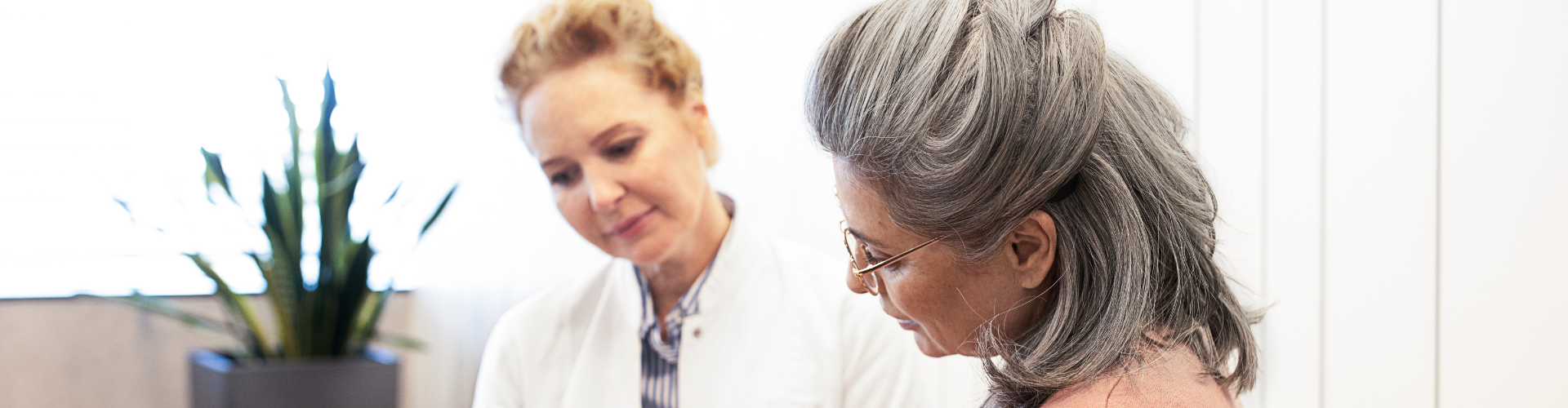 Bimodal Synchronization An audiologist sits next to her patient at the clinic.