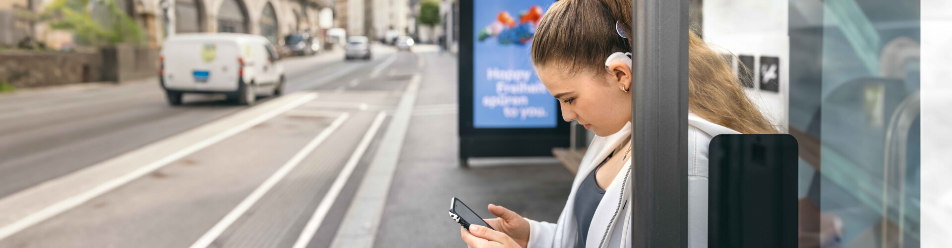 Direct Streaming A teenager uses her SONNET 3s to stream music to her ears while waiting for a bus.