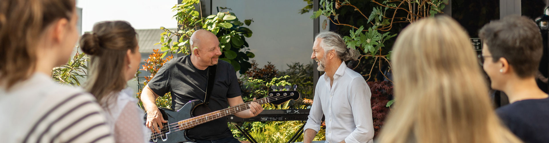 SONNET 3 user plays the bass guitar for a delighted audience.