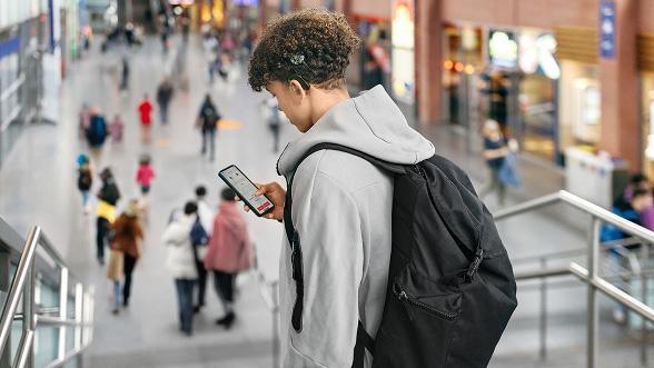teenager at the train station streaming music directly from his smartphone to his SONNET 3