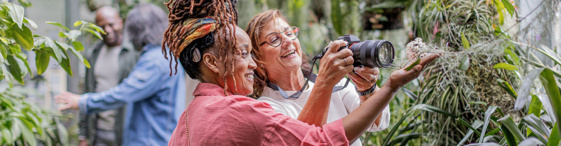 Cochlear implant user can hear and chat with her friend as they take photos together.