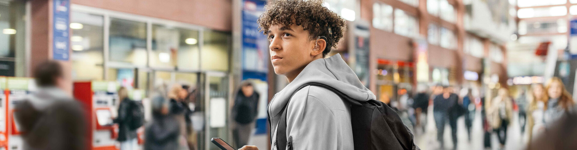 Closest to Natural Hearing teenager at the train station streaming music directly from his smartphone to his SONNET 3